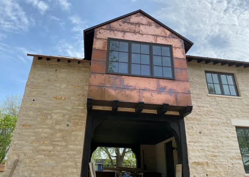 Copper metal panel facade on a stone building for Skylight Installation in Elkton