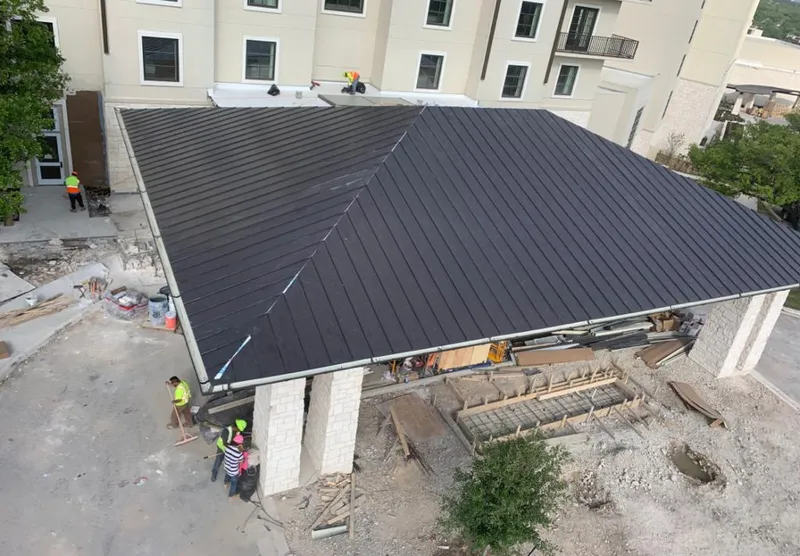 Metal roofing installation team working on a commercial building in Elkton